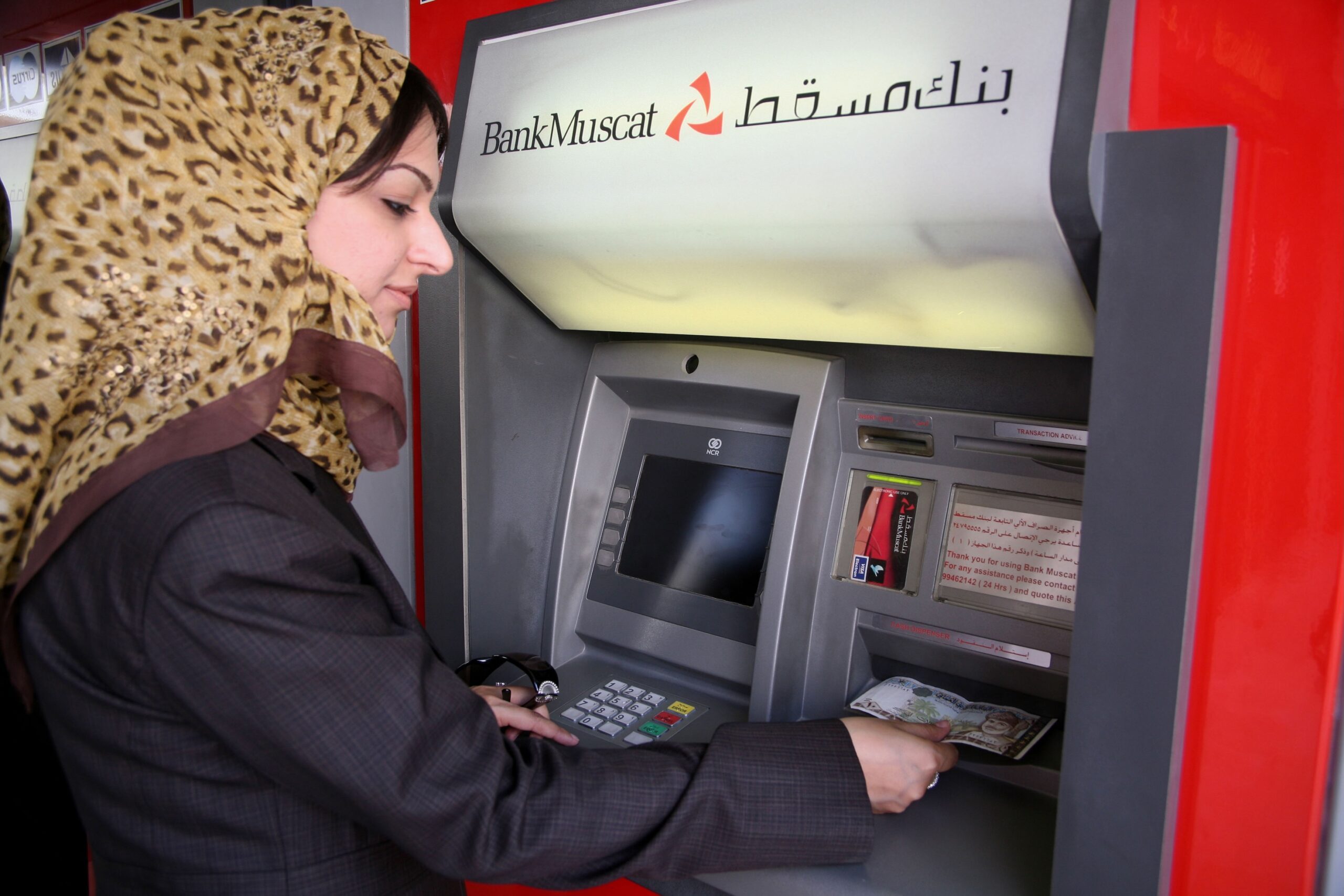 A customer uses a Bank Muscat ATM. Banks in Oman recorded a 15 percent rise in profits in 2024