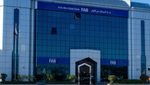 Adani loan: First Abu Dhabi (FAB) Bank blue wide angle storefront on a blue sky sunny day