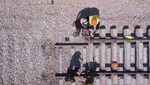 Rail tracks maintenance process. Railroad workers repairing a broken track