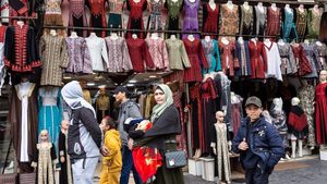 Adult, Female, Person A traditional clothes shop in Amman. The World Bank will provide loans worth $1.1 billion to boost economic growth, as well as build startups and SMEs