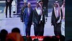 People watch a screen at Riyadh airport as President Donald Trump is met by Crown Prince Mohammed bin Salman