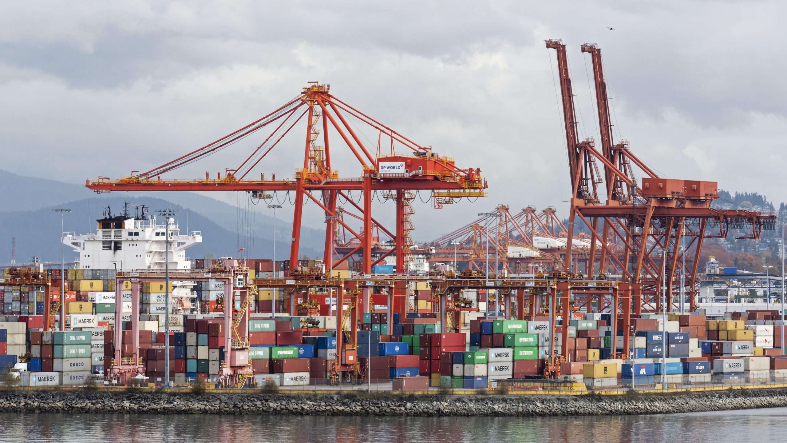 Gantry cranes and shipping containers on Vancouver's downtown waterfront. The Port of Vancouver facility is operated by DP World