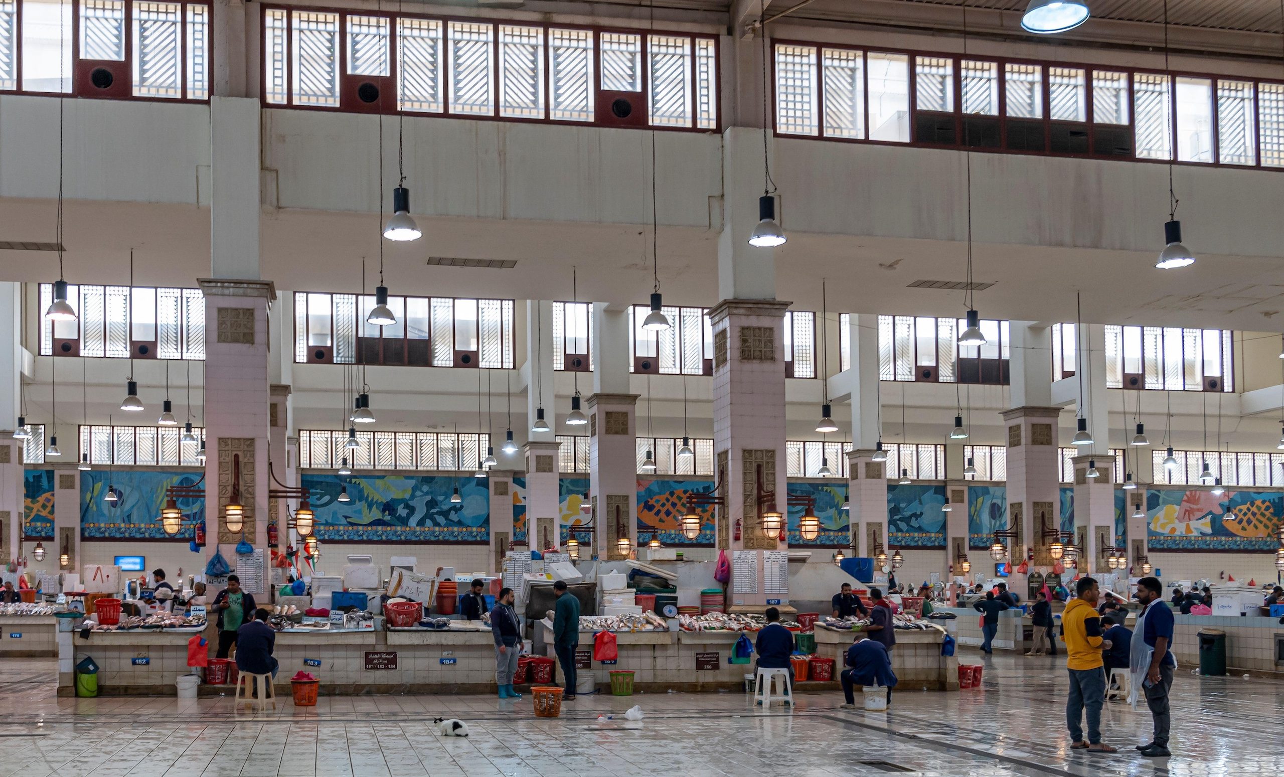 Fishmongers and shoppers at Kuwait City's fish market. The Circle app offers grocery delivery around Kuwait