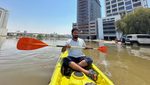A volunteer uses a kayak during a rescue operation through a road flooded due to heavy rains in Dubai, United Arab Emirates, April 18, 2024. REUTERS/Abdel Hadi Ramahi