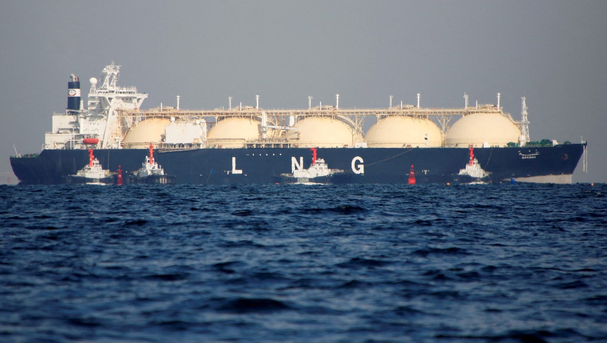 A liquefied natural gas tanker is tugged towards a thermal power station in Futtsu, east of Tokyo, Japan