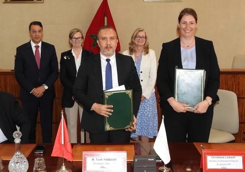 Tarik Hamane, director general of ONEE, left, and Christiane Laibach, executive board member of KfW, sign the loan agreement