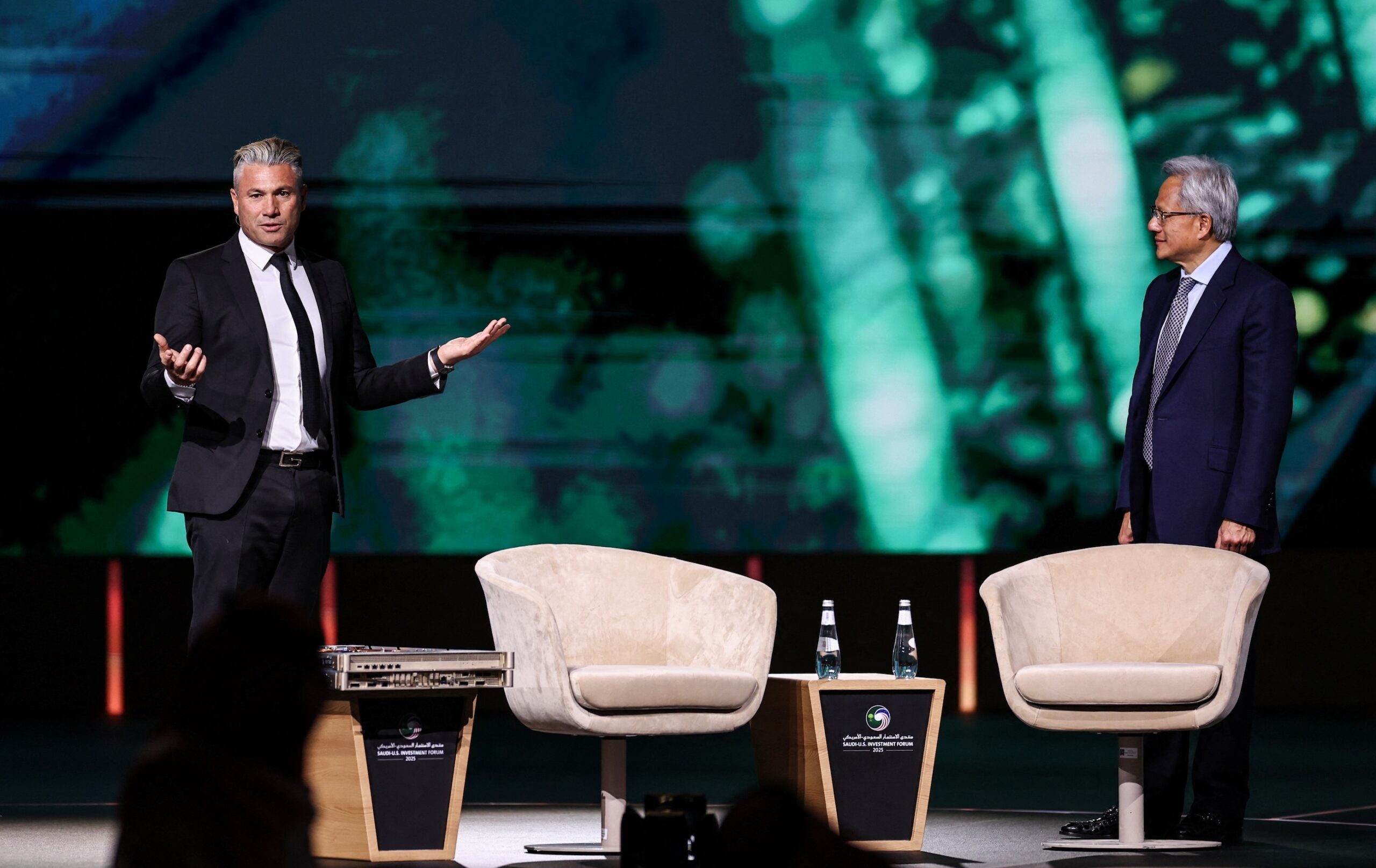 Tareq Amin, CEO of Humain, and Jensen Huang, CEO of Nvidia, on stage at the Saudi-US Investment Forum. PIF-backed Humain is buying 18,000 AI chips from the US company