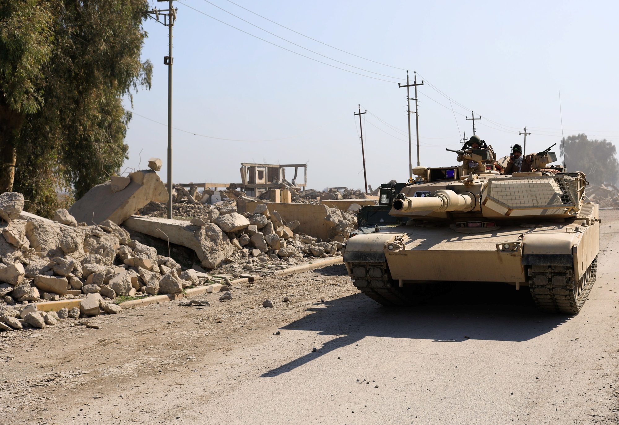 A tank passes the ruins of Mosul airport, which has now undergone a $150m rebuilding project