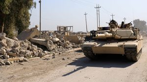 A tank passes the ruins of Mosul airport, which has now undergone a $150m rebuilding project