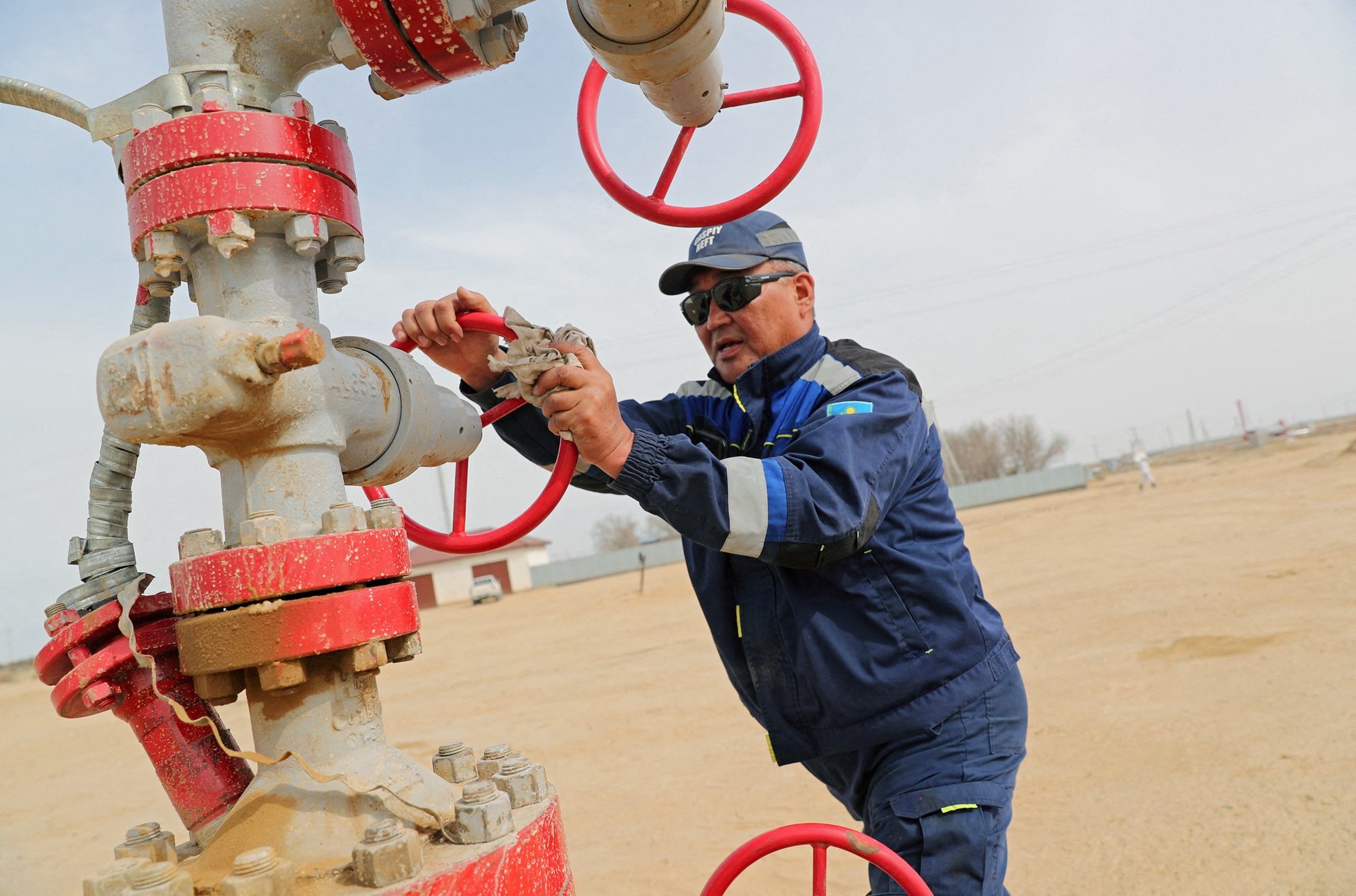 An oil worker in Kazakhstan, which has been exceeding its Opec+ quotas