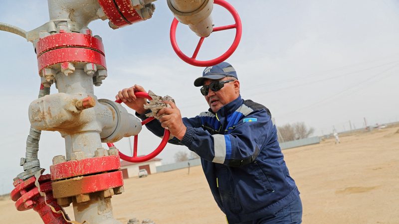 An oil worker in Kazakhstan, which has been exceeding its Opec+ quotas
