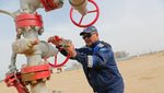 An oil worker in Kazakhstan, which has been exceeding its Opec+ quotas