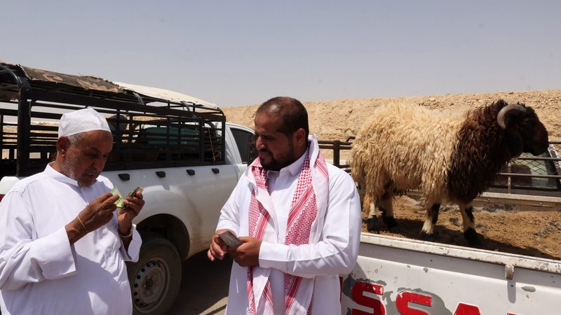 A customer pays for a sheep at a livestock market in Riyadh. Prices jumped by more than SAR2,000 ($533) during Eid Al-Adha, according to a media report