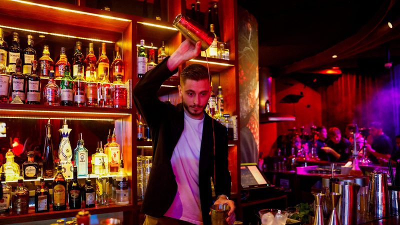 A Russian bartender prepares a drink at the restaurant and Karaoke club Chalet Berezka in Dubai