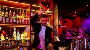 A Russian bartender prepares a drink at the restaurant and Karaoke club Chalet Berezka in Dubai