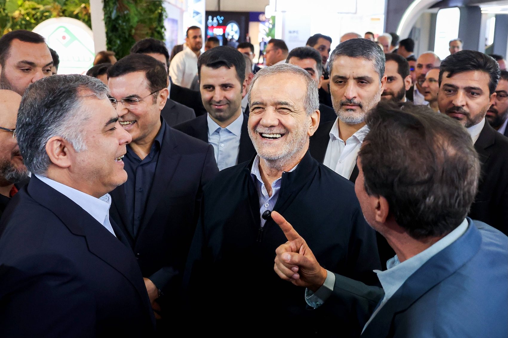 Iranian President Masoud Pezeshkian (centre) visits the Iran Oil Exhibition in Tehran in May