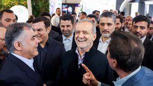 Iranian President Masoud Pezeshkian (centre) visits the Iran Oil Exhibition in Tehran in May