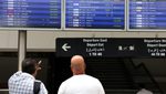 People check display screens showing cancelled flights at Lebanon's Beirut-Rafic Hariri International Airport