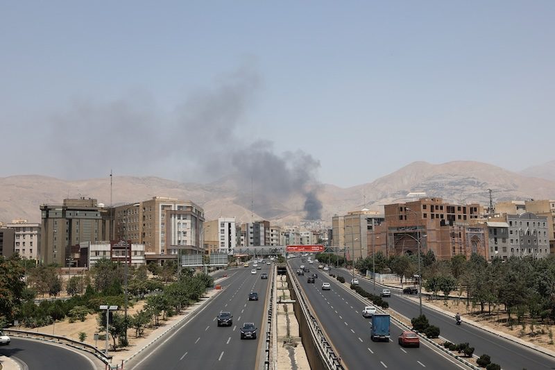 Smoke rises following what Iran says was an Israeli attack on Sharan Oil depot in Tehran on June 16, 2025