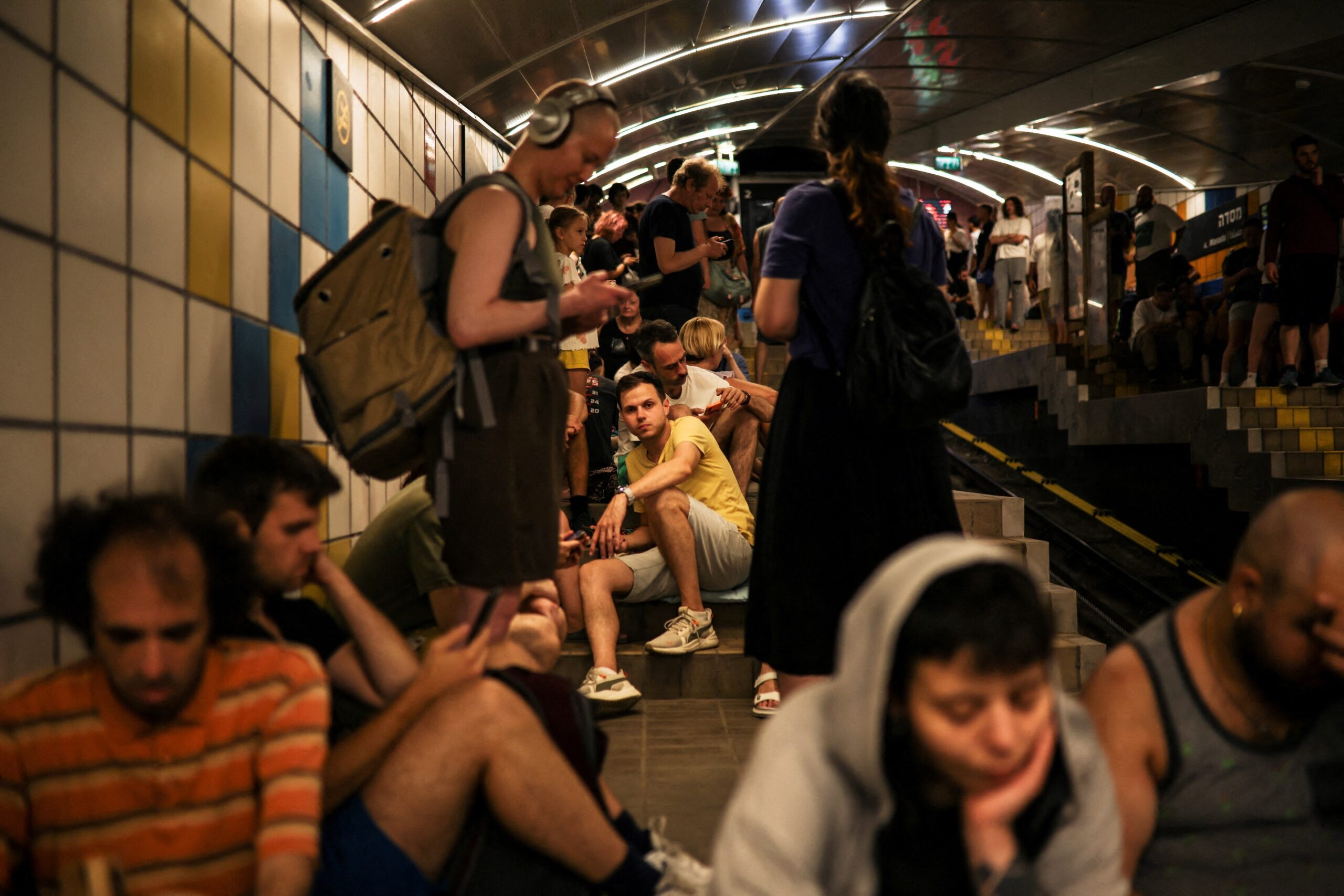 People take cover in a cable car tunnel in Haifa following a missile attack on Israel by Iran