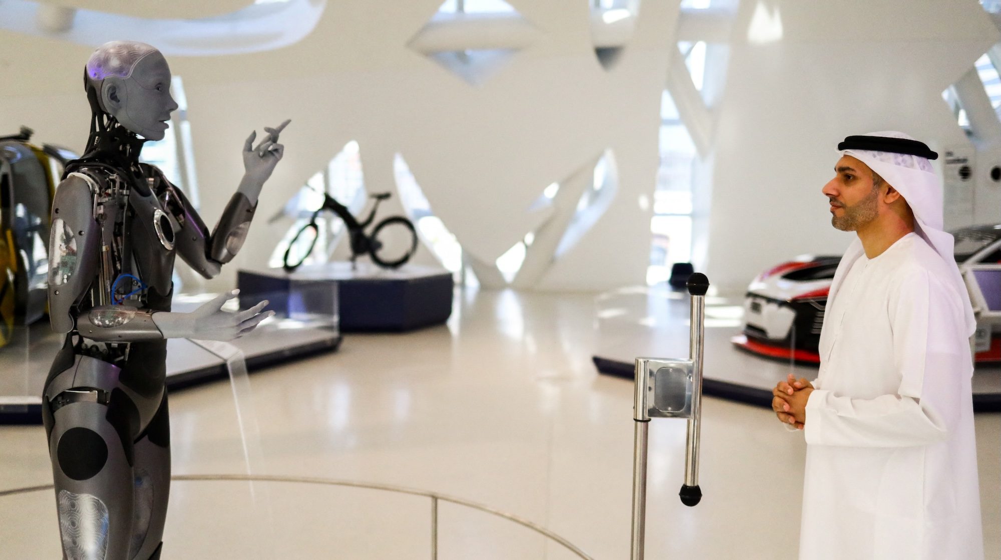 Ameca, a humanoid robot and member of the Museum of the Future staff interacts with the museum’s deputy executive director, Majed Al Mansoori in Dubai,