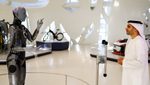 Ameca, a humanoid robot and member of the Museum of the Future staff interacts with the museum’s deputy executive director, Majed Al Mansoori in Dubai,