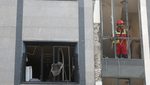 A rescuer looks out from a damaged building in the aftermath of Israeli strikes in Tehran