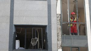 A rescuer looks out from a damaged building in the aftermath of Israeli strikes in Tehran