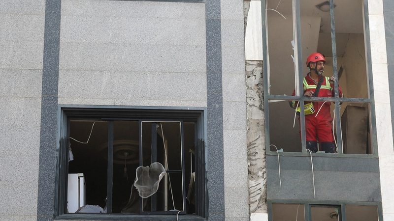 A rescuer looks out from a damaged building in the aftermath of Israeli strikes in Tehran