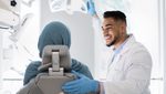 2GF2YC5 Young Arab Dentist Doctor Having Check Up With Islamic Female Patient