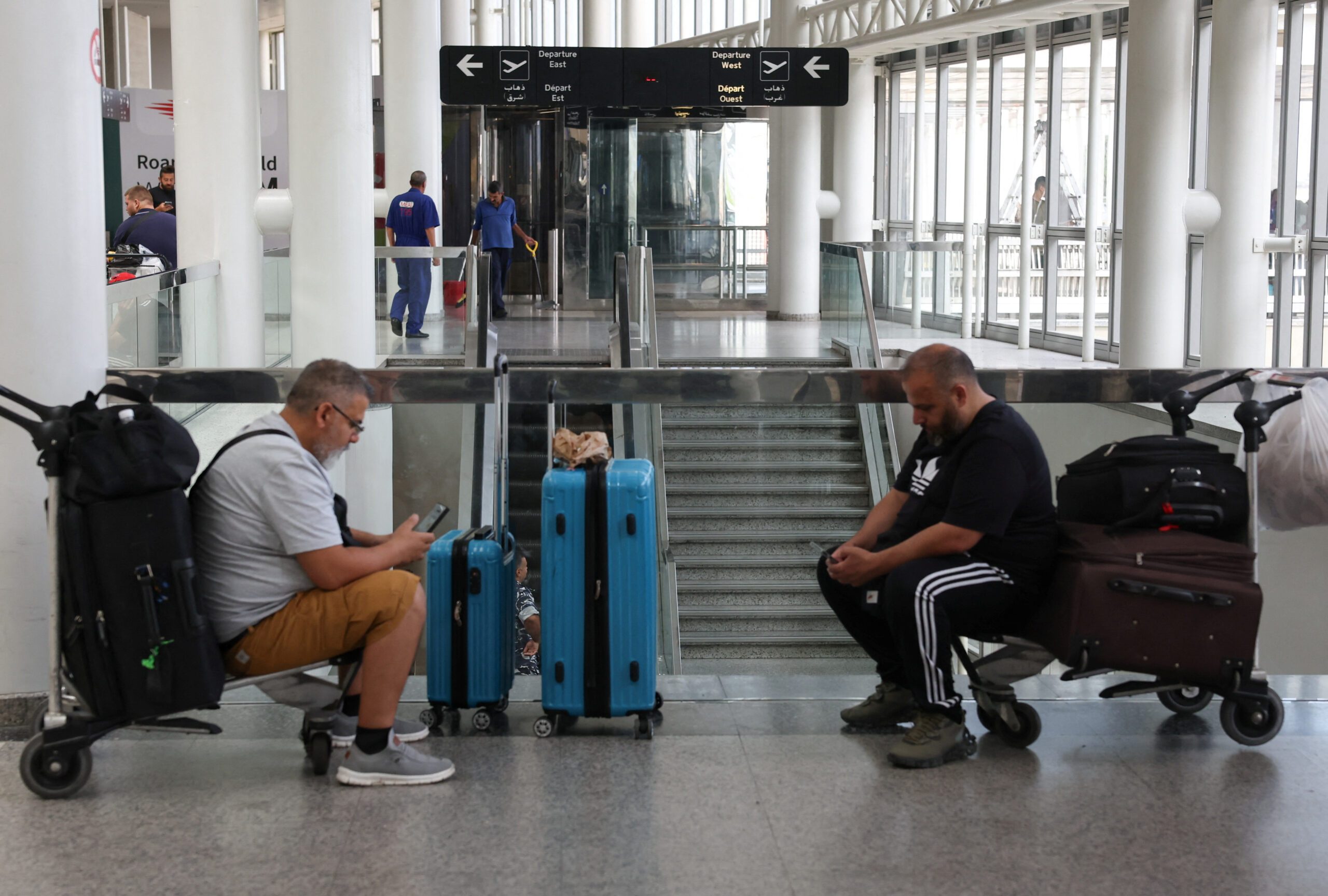 People wait for their flight at Lebanon's Beirut-Rafic Hariri airport during schedule disruptions stemming from the Iran-Israel conflict