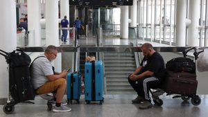 People wait for their flight at Lebanon's Beirut-Rafic Hariri airport during schedule disruptions stemming from the Iran-Israel conflict