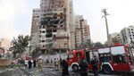 Firefighters at a damaged building in the aftermath of Israeli strikes, in Tehran, Iran