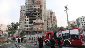 Firefighters at a damaged building in the aftermath of Israeli strikes, in Tehran, Iran