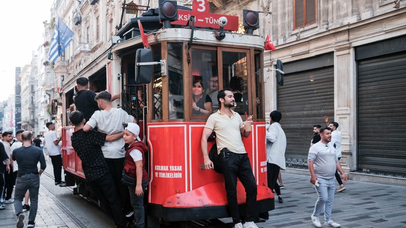 People are seen riding on a tram in Taksim. Turkish debt