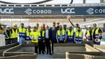 Workers celebrate the start of construction for 3D-printed buildings, part of a larger school-building project in Qatar
