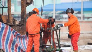 Workers in the Daqing oil field in Northern China. Iraq is looking at investments in Asian oil