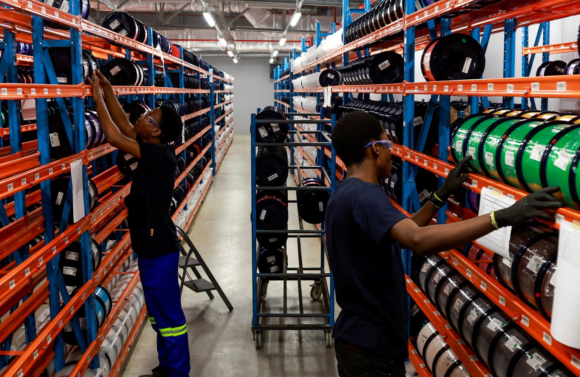 Workers at a fibre optic cable production facility. Syria plans to spend up to $300 million to improve its communications network