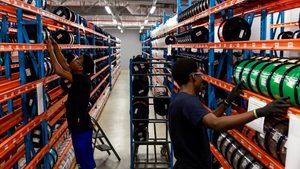 Workers at a fibre optic cable production facility. Syria plans to spend up to $300 million to improve its communications network