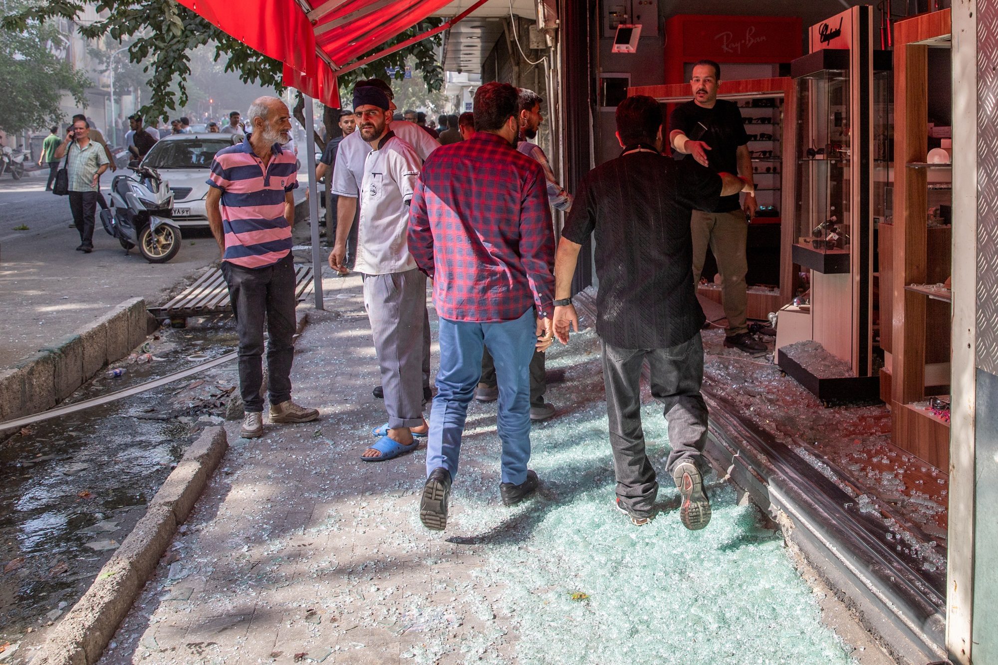 People gather in the street following the Israeli strikes on Iran