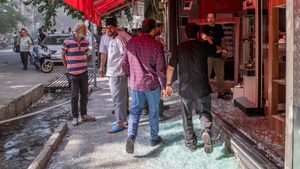 People gather in the street following the Israeli strikes on Iran