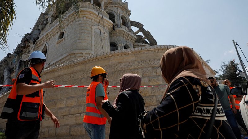 Emergency workers survey the damage after missiles fired from Iran hit a residential building, in Tamra, northern Israel. The conflict is affecting most Gulf stock markets