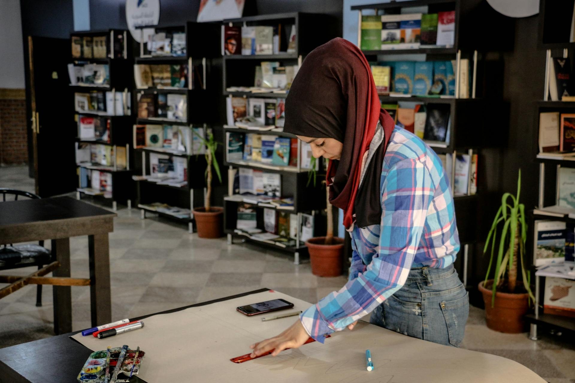 A woman working in Aleppo. Syrian people will be able to to use crypto trading platform Binance