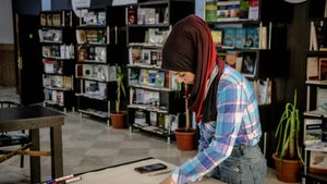 A woman working in Aleppo. Syrian people will be able to to use crypto trading platform Binance